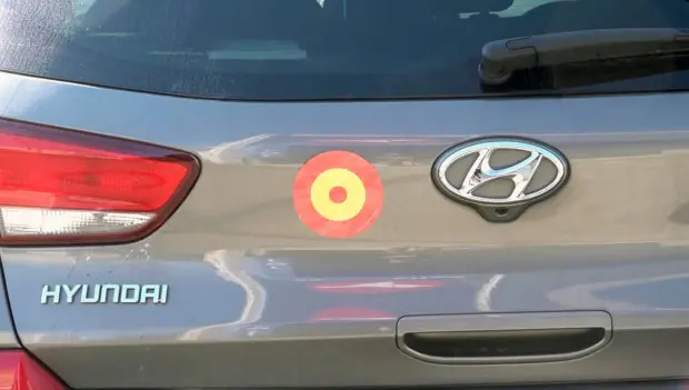 What Does the Red-and-Yellow Target Symbol on the Back of Some Cars Mean?