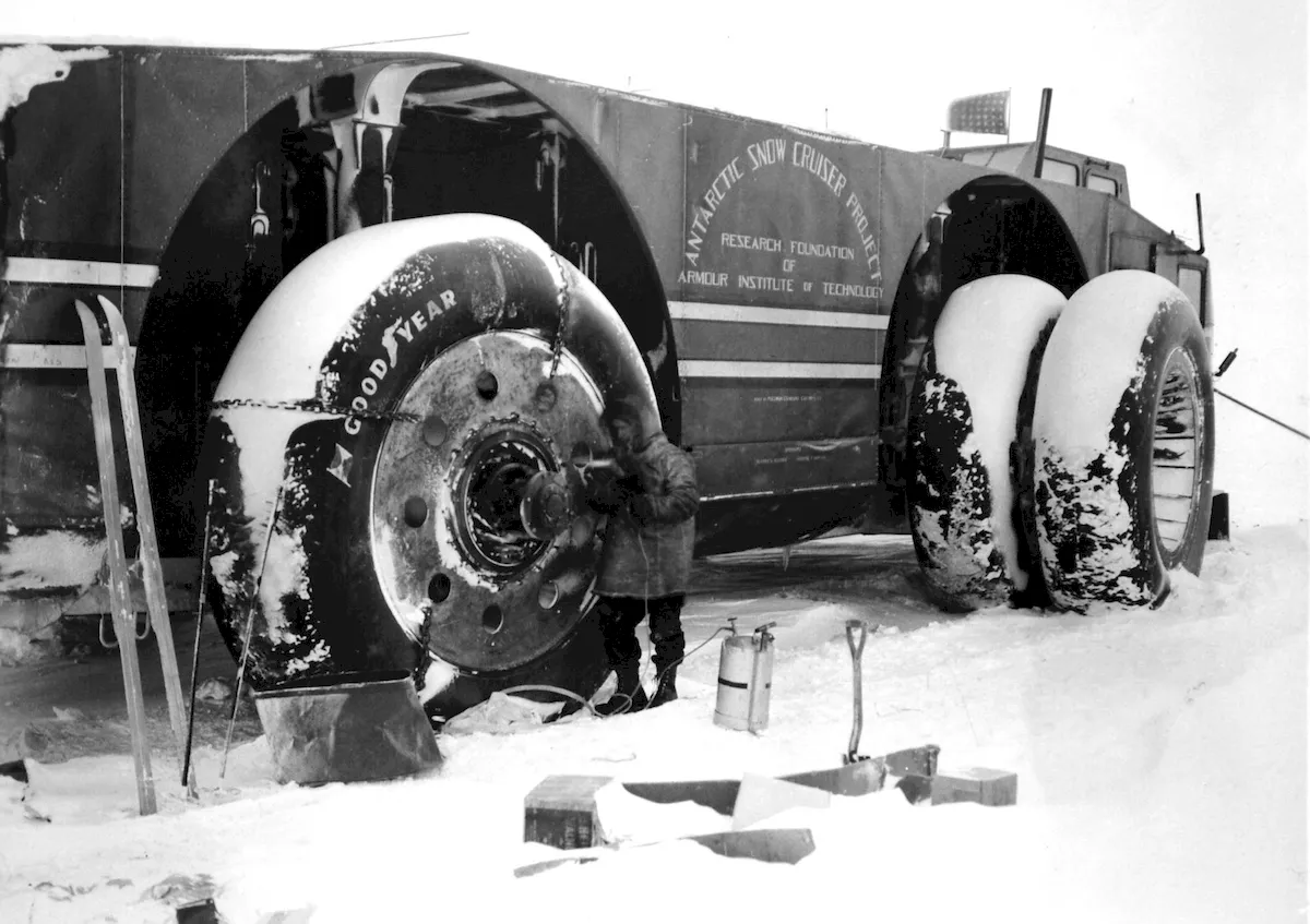Sergeant Felix Ferranto, the radio operator, uses a Primus blowtorch to thaw out the wheelhub motors of the Antarctic Snow Cruiser on August 23, 1940.