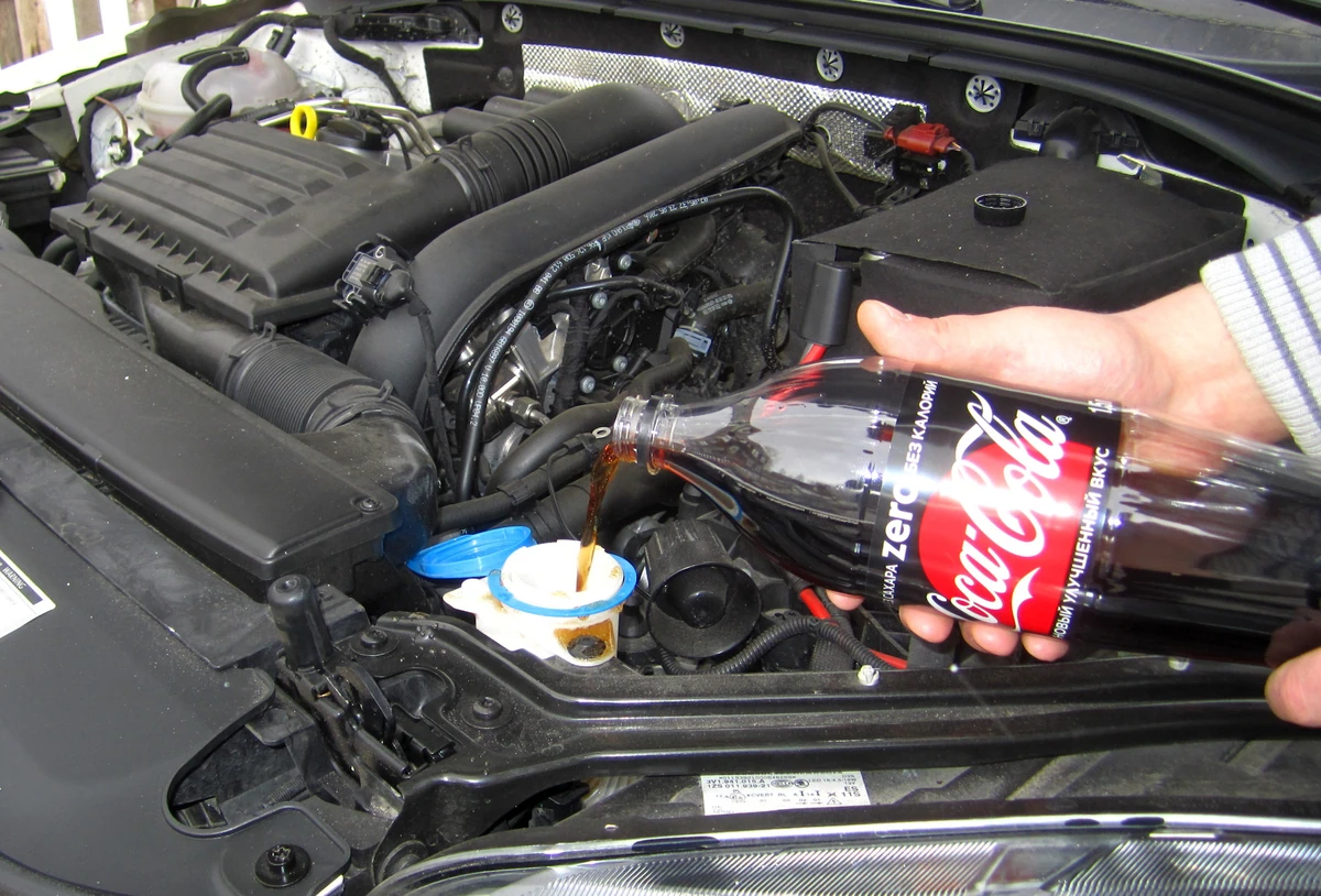 You can also use Coca-Cola Zero to clean out the windshield washer nozzles / washer fluid channels